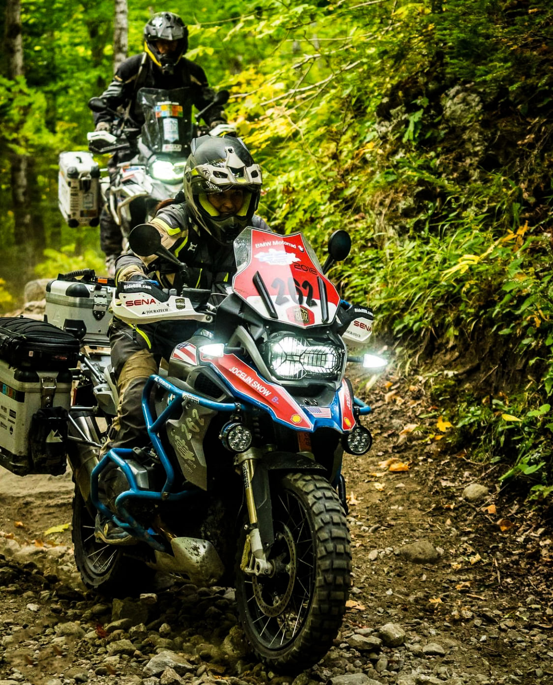 Jocelin Snow and Paul Guillien riding through the forest